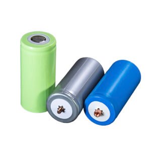 Blue and green cylindrical 32700 LiFePO4 cells arranged on a white background.